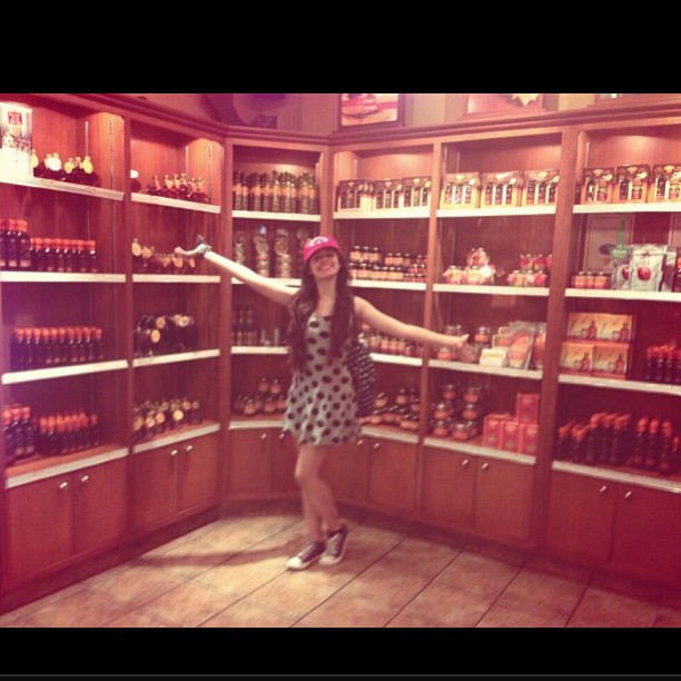 taking a picture in front of the maple syrup wearing a Canada hat, couldn't be m...