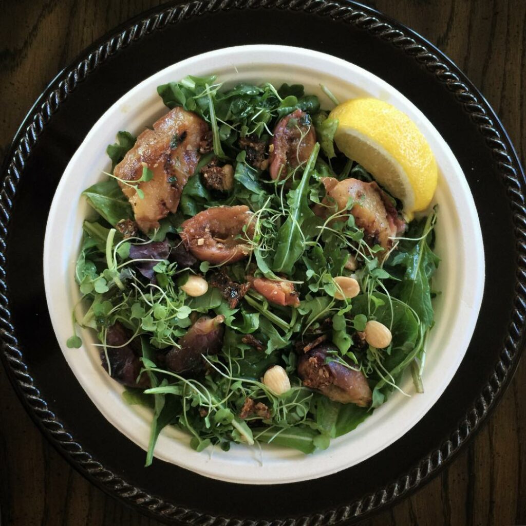 grilled figs + peaches on arugula topped with micro + truffled almonds. tossed i...