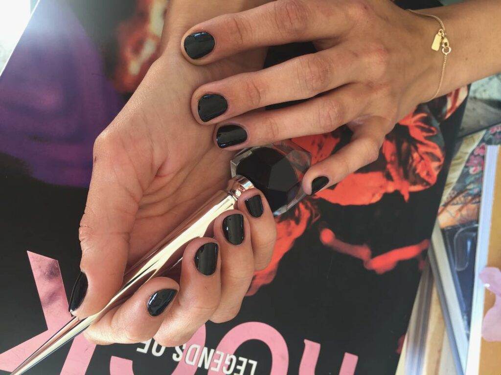My nails have red soles. Murdered out mani by tiny goddess @stephstonenails! #do...