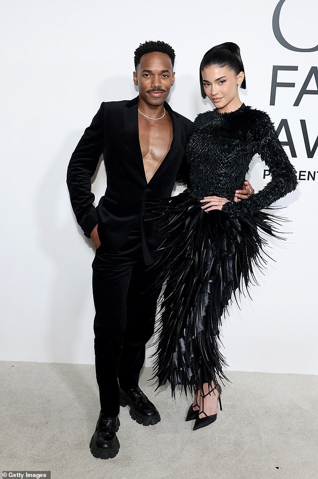 While at the event she posed with pal Carter Gregory, who went shirtless underneath a black velvet suit