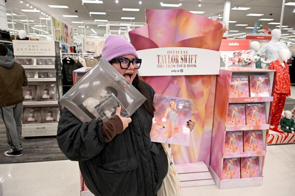 A shopper with Taylor Swift items at Target on Black Friday.