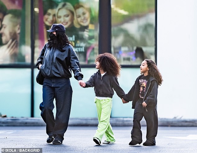 The cosmetics mogul also wore all black clothing as she hid her figure in an oversized black leather jacket and baggy blue denim slacks. For comfort the Keeping Up With The Kardashians veteran wore adidas sneakers