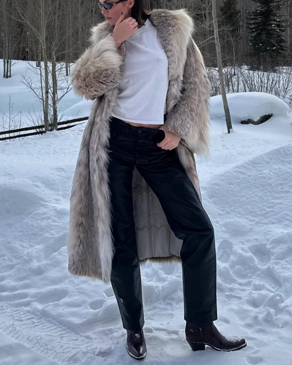 person dressed in winter attire standing in a snowy environment