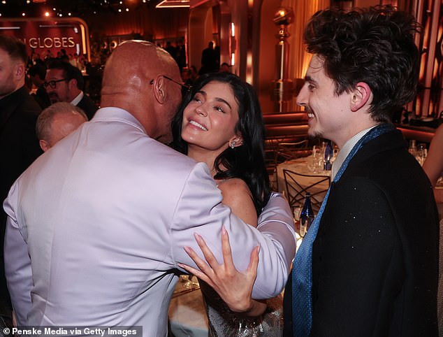 'She wanted this night to be all about Timothee, how it was intended to be,' the source told Page Six; the pair are seen at the ceremony with Dwayne 'The Rock' Johnson