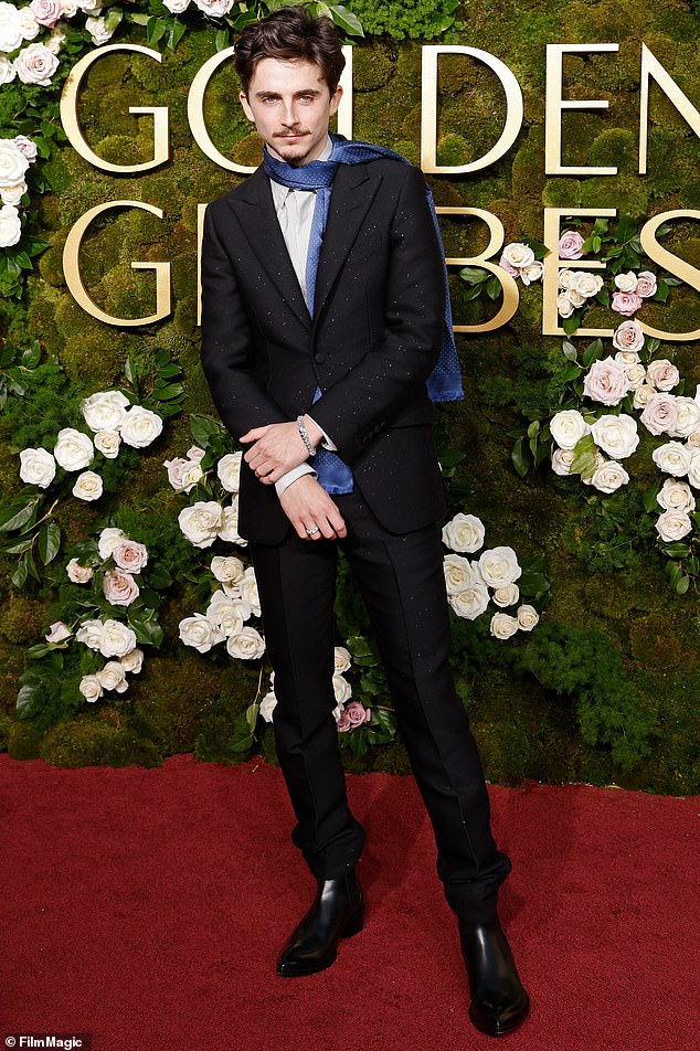 Timothee hit the carpet solo, wearing a scarf in place of a tie in a tribute to the boho chic that became an indelible part of Bob Dylan's image