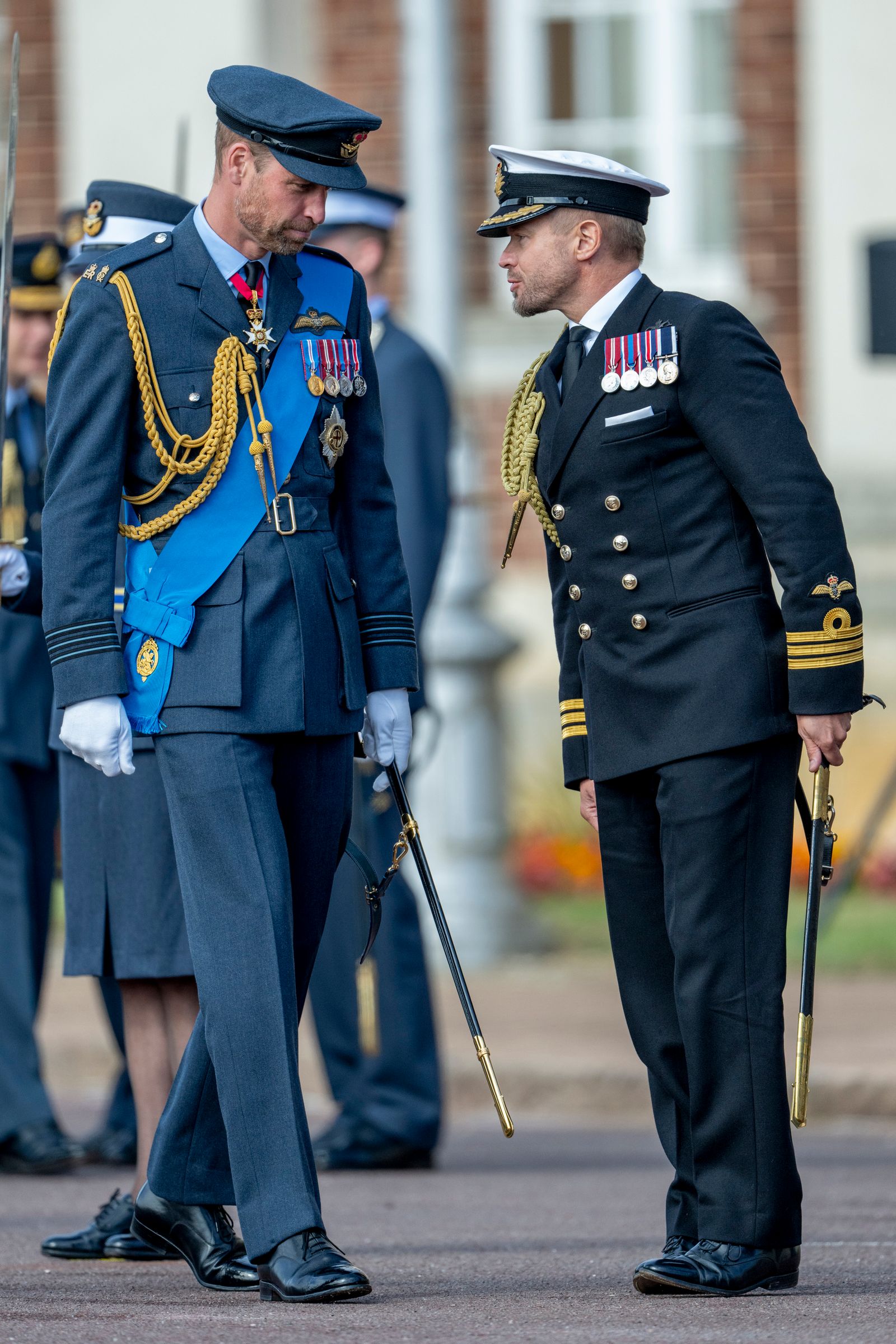 Image may contain Prince William Duke of Cambridge Walter Jones Officer Person Clothing Glove Hat Footwear and Shoe