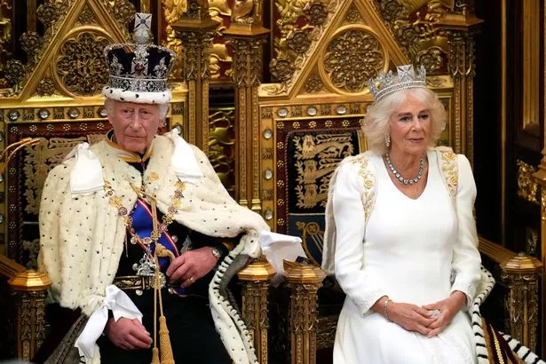  King Charles III, wearing the Imperial State Crown and the Robe of State, sits alongside Britain's Queen Camilla, wearing the George IV State Diadem, before reading the King's Speech from the The Sovereign's Throne in the House of Lords chamber, during the State Opening of Parliament, at the Houses of Parliament, on July 17, 2024 in London, England. 