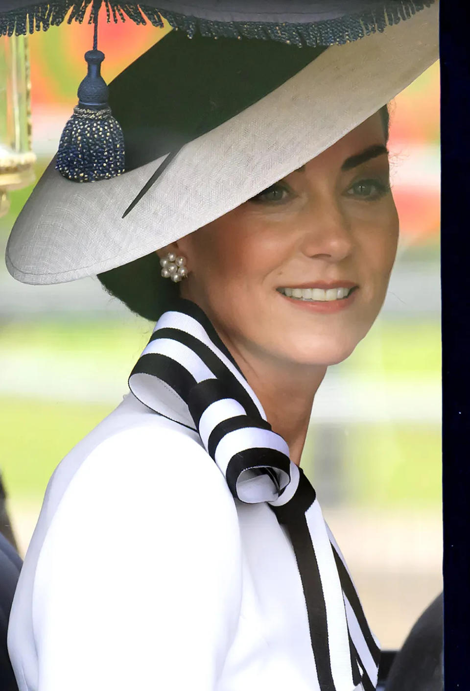 A close-up of Kate Middleton smiling from a carriage at Trooping the Colour