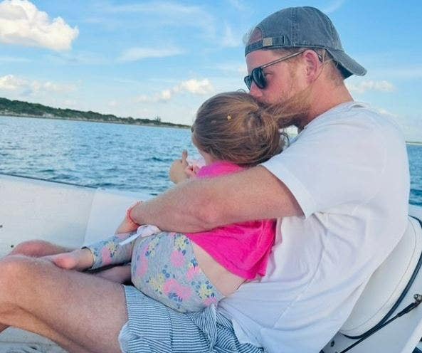 Princess Lilibet cradled by Prince Harry