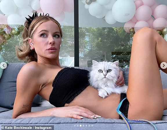 Kate Beckinsale tried to pose for pictures with her cat and dog on Sunday but the feline had other ideas