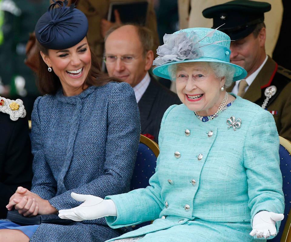 Kate Middleton, then-Duchess of Cambridge and Queen Elizabeth II watch part of a children's sports event while visiting Vernon Park during a Diamond Jubilee visit to Nottingham on June 13, 2012 in Nottingham, England