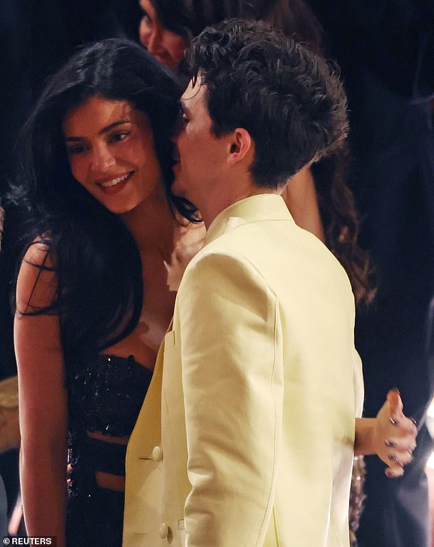 The makeup mogul turned heads in a barely-there, strappy black gown, exuding effortless glamour as she cozied up to Chalamet, who is nominated for Best Actor for his portrayal of Bob Dylan in A Complete Unknown