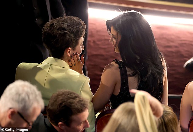 Kylie Jenner gently touches Timothee Chalamet's face during the Oscars