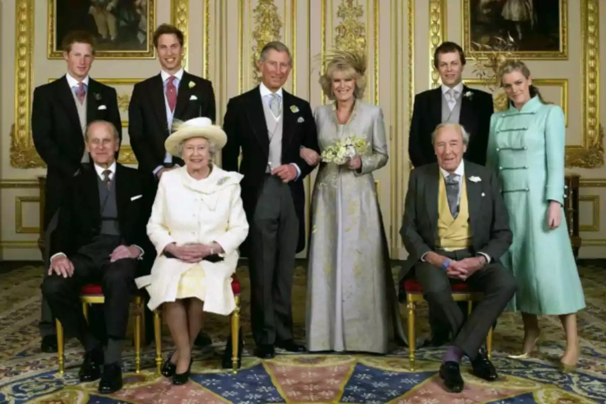 A group of elegantly dressed people posing in a room decorated with golden details and a colorful carpet.