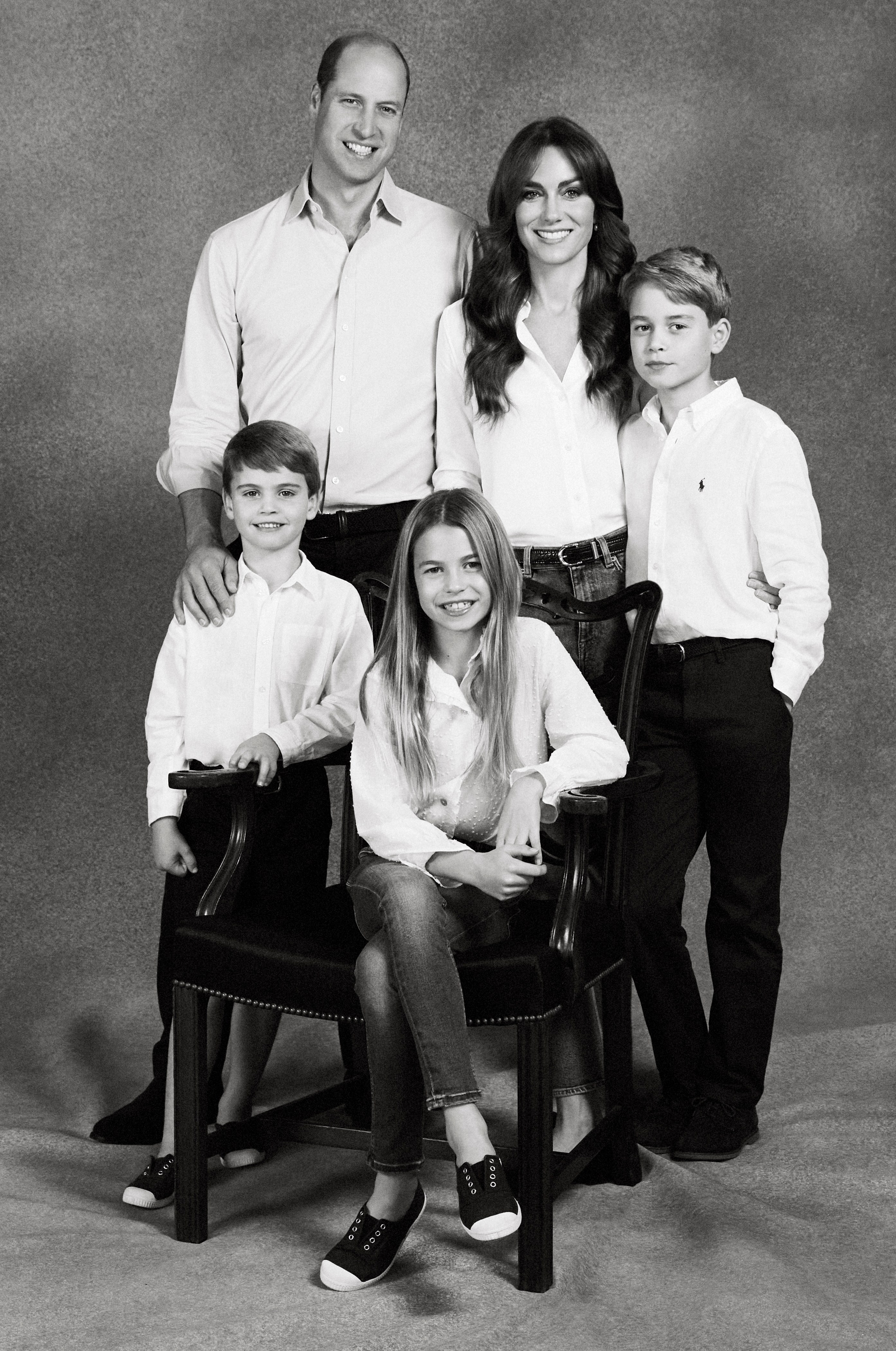 Black and white photo of the Prince and Princess of Wales with their three children for their Christmas card.