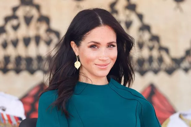 Meghan Markle in a blue dress.