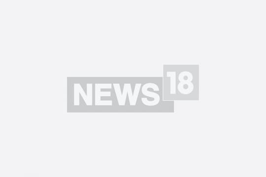 Britain's Prince Harry, Duke of Sussex, walks with security as he arrives at the Royal Courts of Justice, Britain's High Court, in London. (Image: JUSTIN TALLIS/AFP)