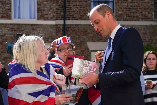 Prince William, Prince of Wales speaks with well wishers after he visits James' Place Newcastle on April 30, 2024