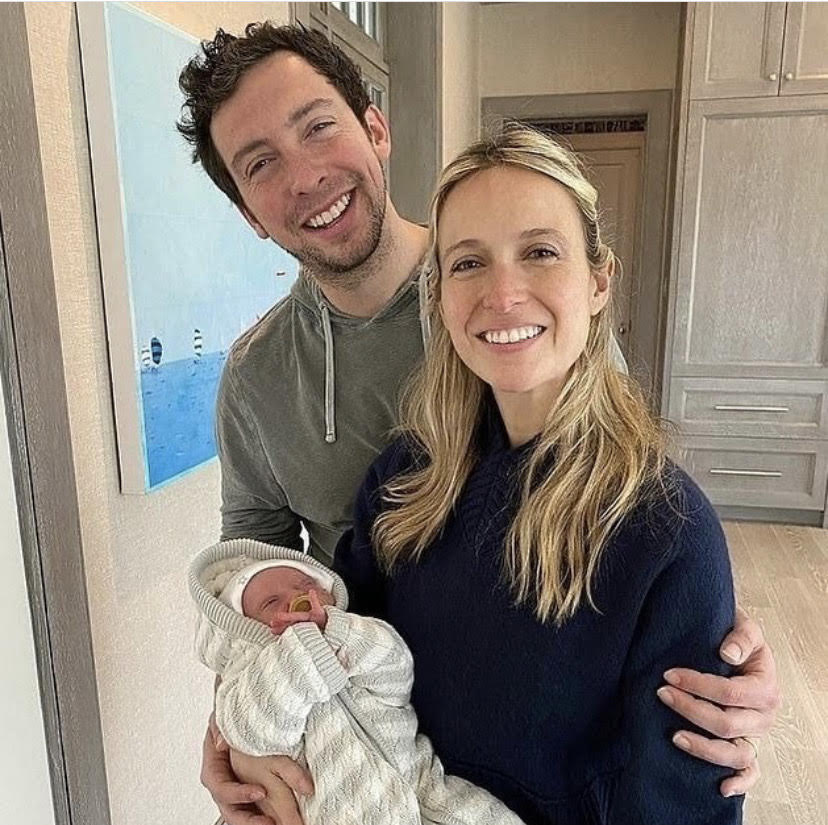 A couple holding their newborn baby.