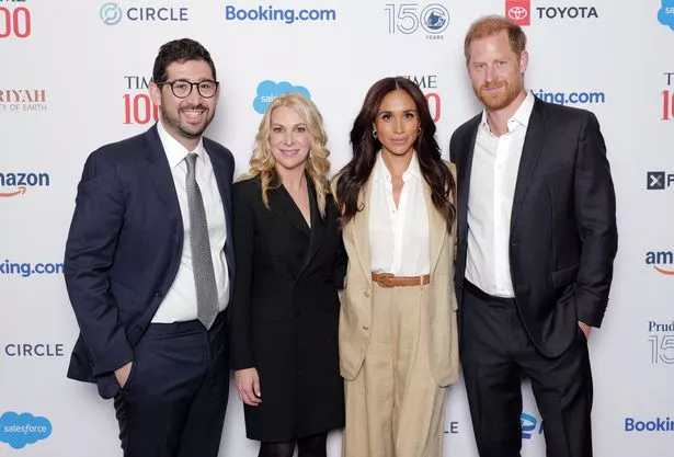 Harry and Meghan pose on the red carpet with Sam Jacobs and Jessica Sibley from TIME