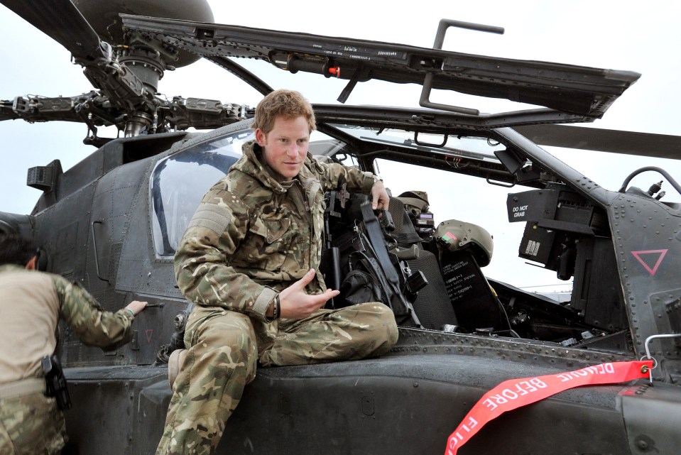 Prince Harry in Afghanistan, sitting in an Apache helicopter.