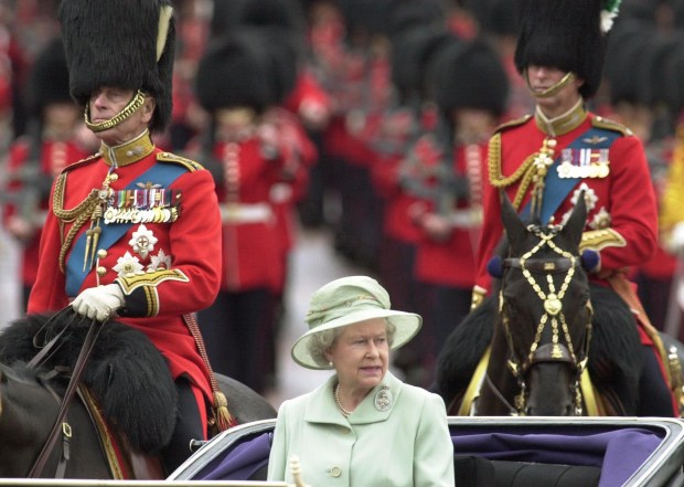 Queen Elizabeth II is escorted by her husband, Prince Philip,...