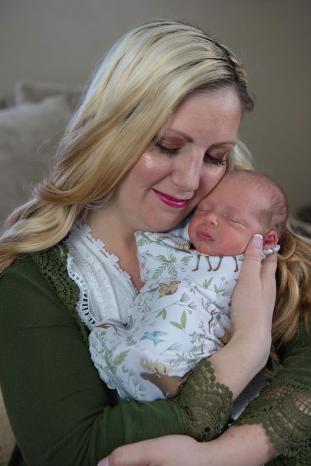 A mother holding her newborn baby.