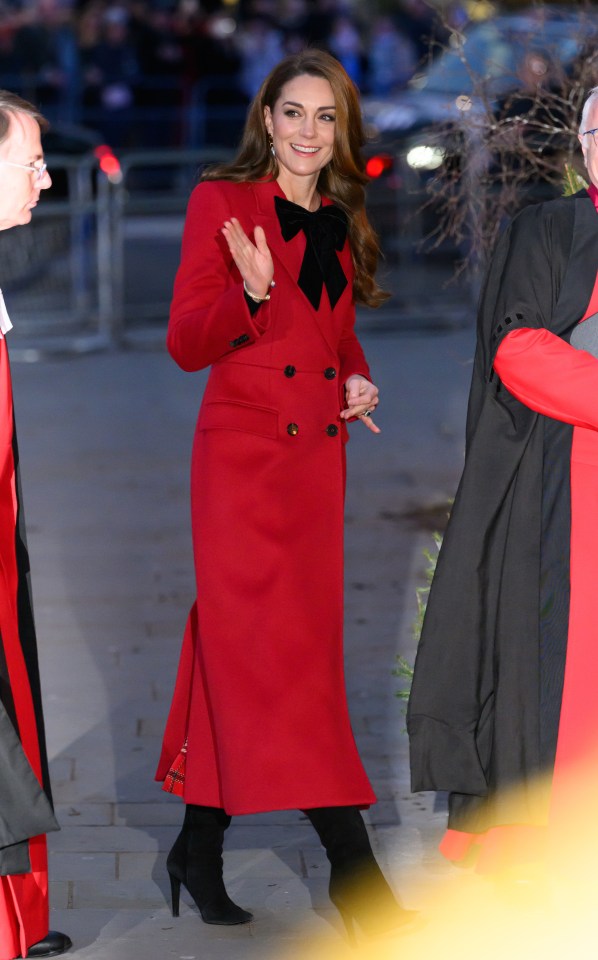 Catherine, Princess of Wales, in a red coat, waves.