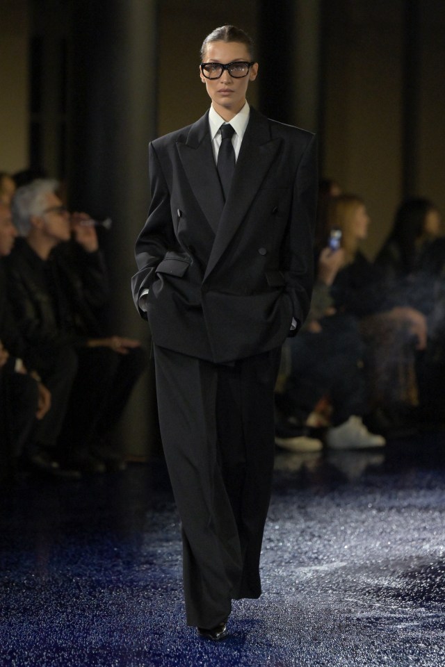 Bella Hadid modeling a black suit at Paris Fashion Week.
