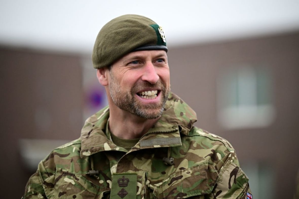 A person wearing camouflage military gear looks to their left.