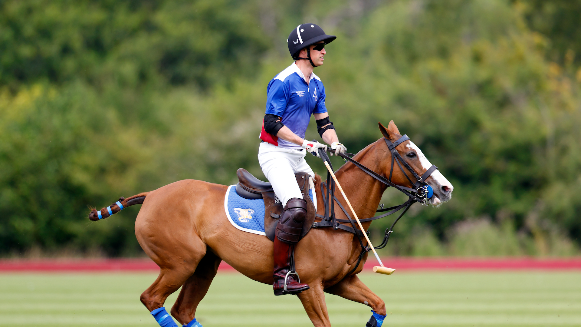 Prince William, Prince of Wales takes part in the Out-Sourcing Inc. Royal Charity Polo Cup 2024 at The Castle Ground, Guards Polo Club, Flemish Farm on July 12, 2024 in Windsor, England