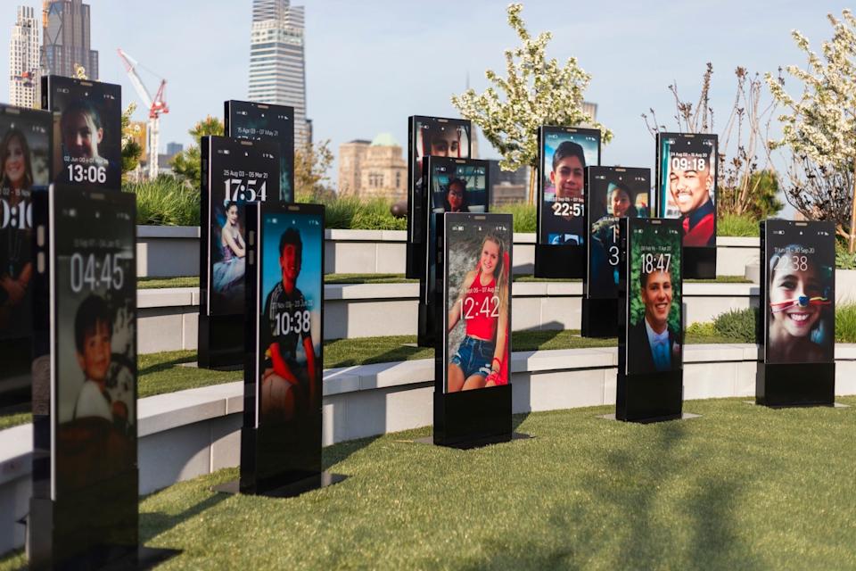 A display of oversize phone lock screens with photos of kids.