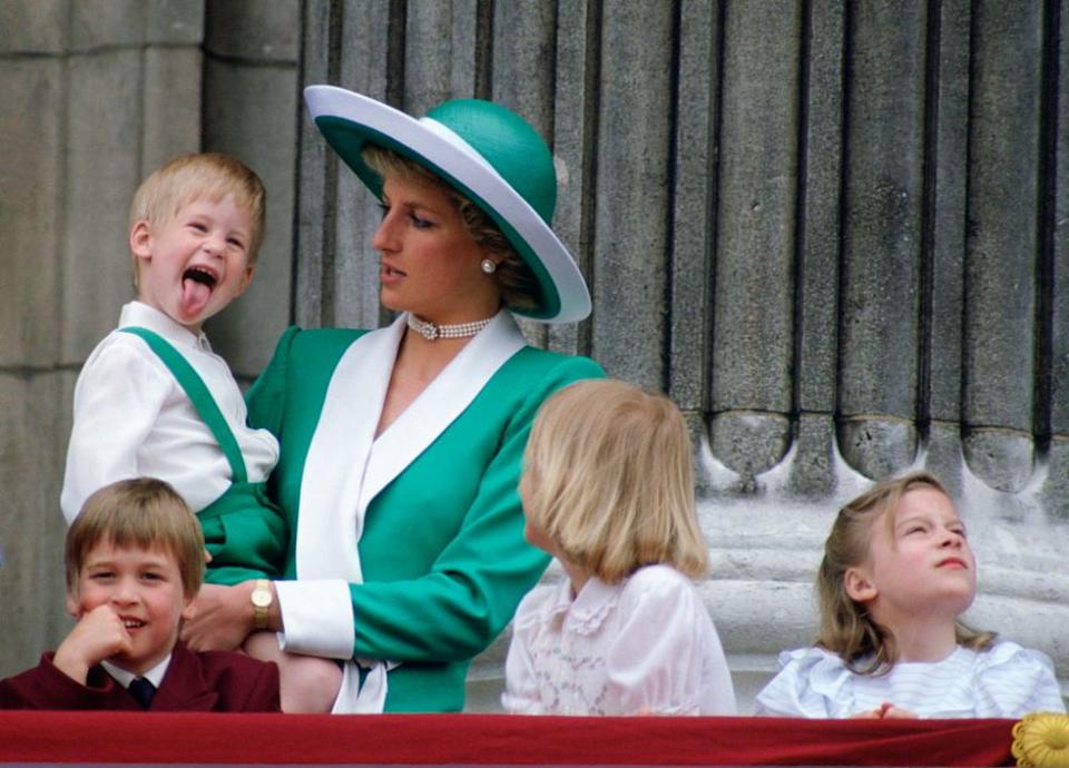 LONDON, UNITED KINGDOM – JUNE 11: Prince Harry Sticking His Tongue Out Much To The Suprise Of His Mother, Princess Diana At Trooping The Colour With Prince William, Lady Gabriella Windsor And Lady Rose Windsor Watching From The Balcony Of Buckingham Palace (Photo by Tim Graham Photo Library via Getty Images)
