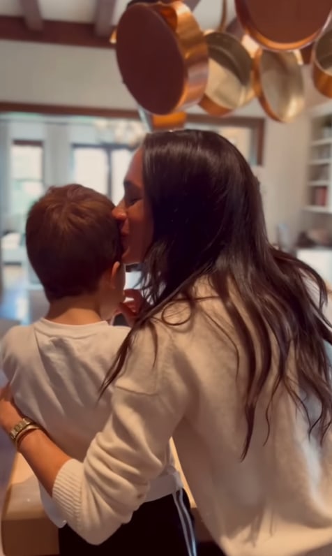 Meghan kisses Prince Archie on the head while they bake cookies in their kitchen