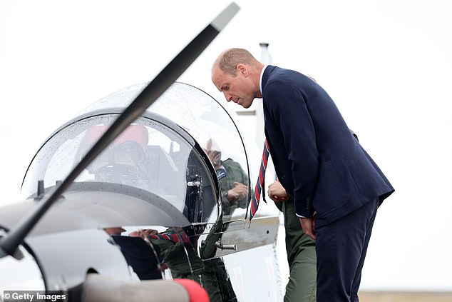 William looked intently inside the aircraft as he learned about the operations
