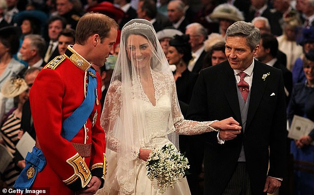 Prince William talking to his new wife Kate Middleton and father-in-law Michael Middleton on their wedding day in 2011
