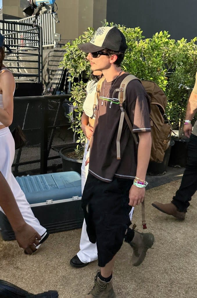 The reality star wore a white crop top and pants. BACKGRID