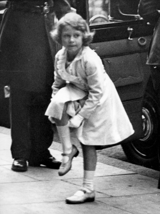 The queen, as princess Elizabeth, pulls her stockings up as...
