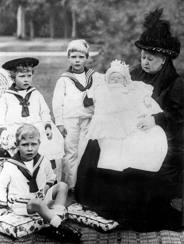 Queen Victoria is pictured with her great-grandchildren, 1900. At left...