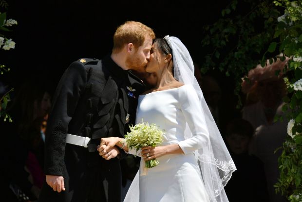 Britain’s Prince Harry and Meghan Markle leave after their wedding...