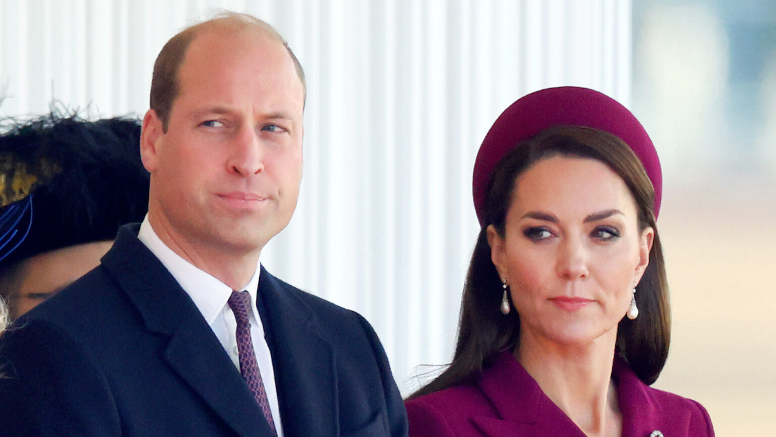 Prince William and Princess Kate Could Take Legal Action Over These Spring Break Photos Prince William wears a suit and Kate Middleton wears a burgundy coat with matching hat