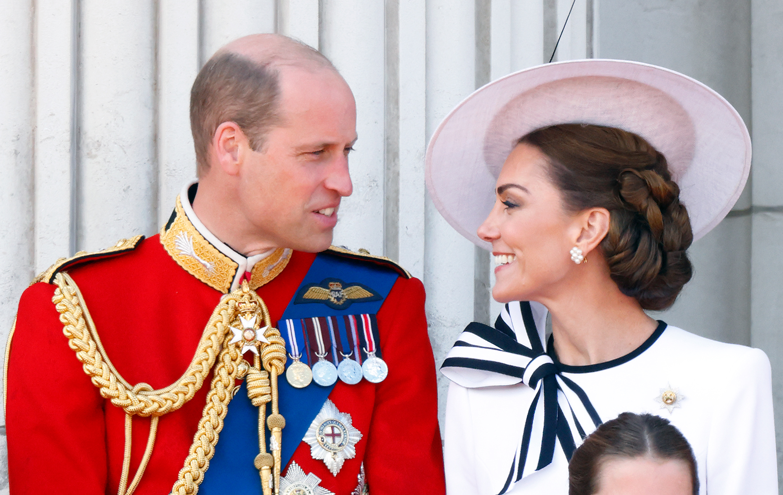 Kate Middleton and Prince William smiling on the balcony of Buckingham Palace during Trooping the Colour 2024