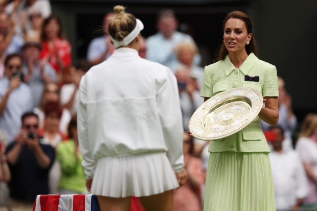 Britain's Catherine, Princess of Wales (R) gives the Venus Rosewater Dish trophy to Czech Republic's Marketa Vondrousova during the prize ceremony after winning the women's singles final tennis match against Tunisia's Ons Jabeur on the thirteenth day of the 2023 Wimbledon Championships at The All England Lawn Tennis Club in Wimbledon, southwest London, on July 15, 2023. (Photo by Adrian DENNIS / AFP) / RESTRICTED TO EDITORIAL USE (Photo by ADRIAN DENNIS/AFP via Getty Images)