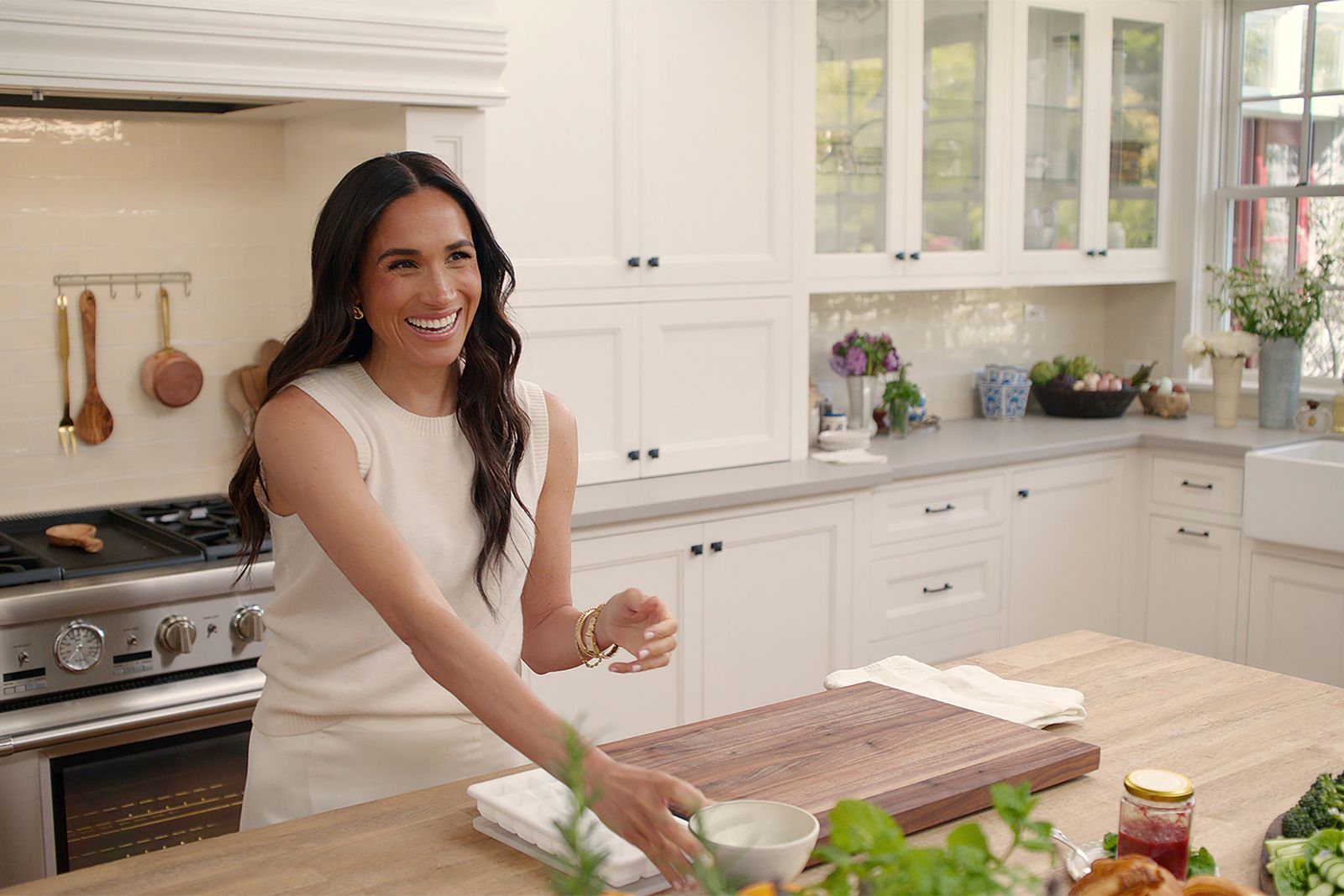 Image may contain Meghan Duchess of Sussex Adult Person Cooktop Indoors Kitchen Cup Sink Bread and Food