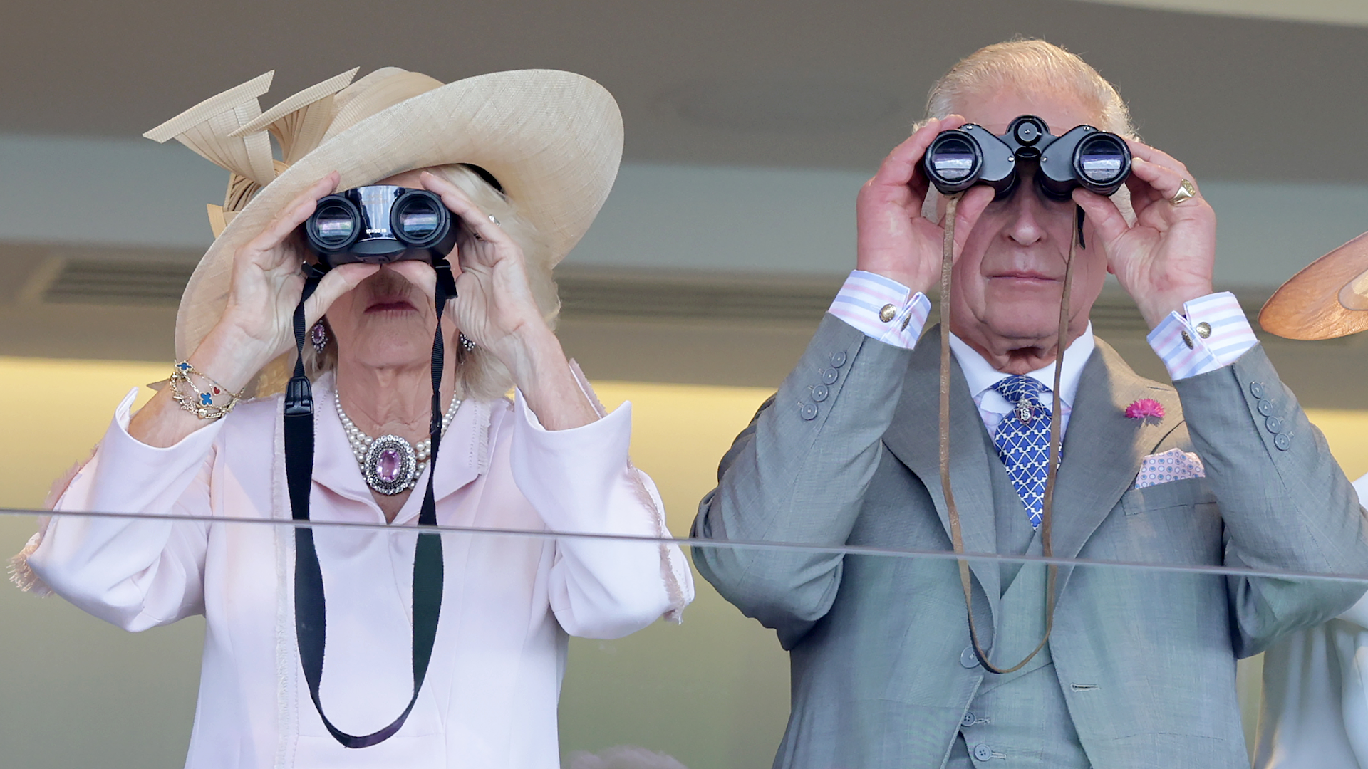 Queen Camilla and King Charles III use binoculars as they watch a race from the Royal Box during day two of Royal Ascot 2023 at Ascot Racecourse on June 21, 2023 in Ascot, England