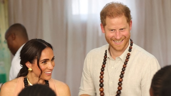 Britain's Meghan (L), Duchess of Sussex, and Britain's Prince Harry (C), Duke of Sussex, speak with students at the Lightway Academy in Abuja on May 10, 2024 as they visit Nigeria as part of celebrations of Invictus Games anniversary. (Photo by Kola Sulaimon / AFP)(AFP)