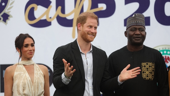 Britain's Meghan (L), Duchess of Sussex, Britain's Prince Harry (C), Duke of Sussex, and Nigeria Chief of Defense Staff Christopher Musa (R) react as they pose for a photo after a charity polo game at the Ikoyi Polo Club in Lagos on May 12, 2024 as they visit Nigeria as part of celebrations of Invictus Games anniversary. (Photo by Kola Sulaimon / AFP)(AFP)