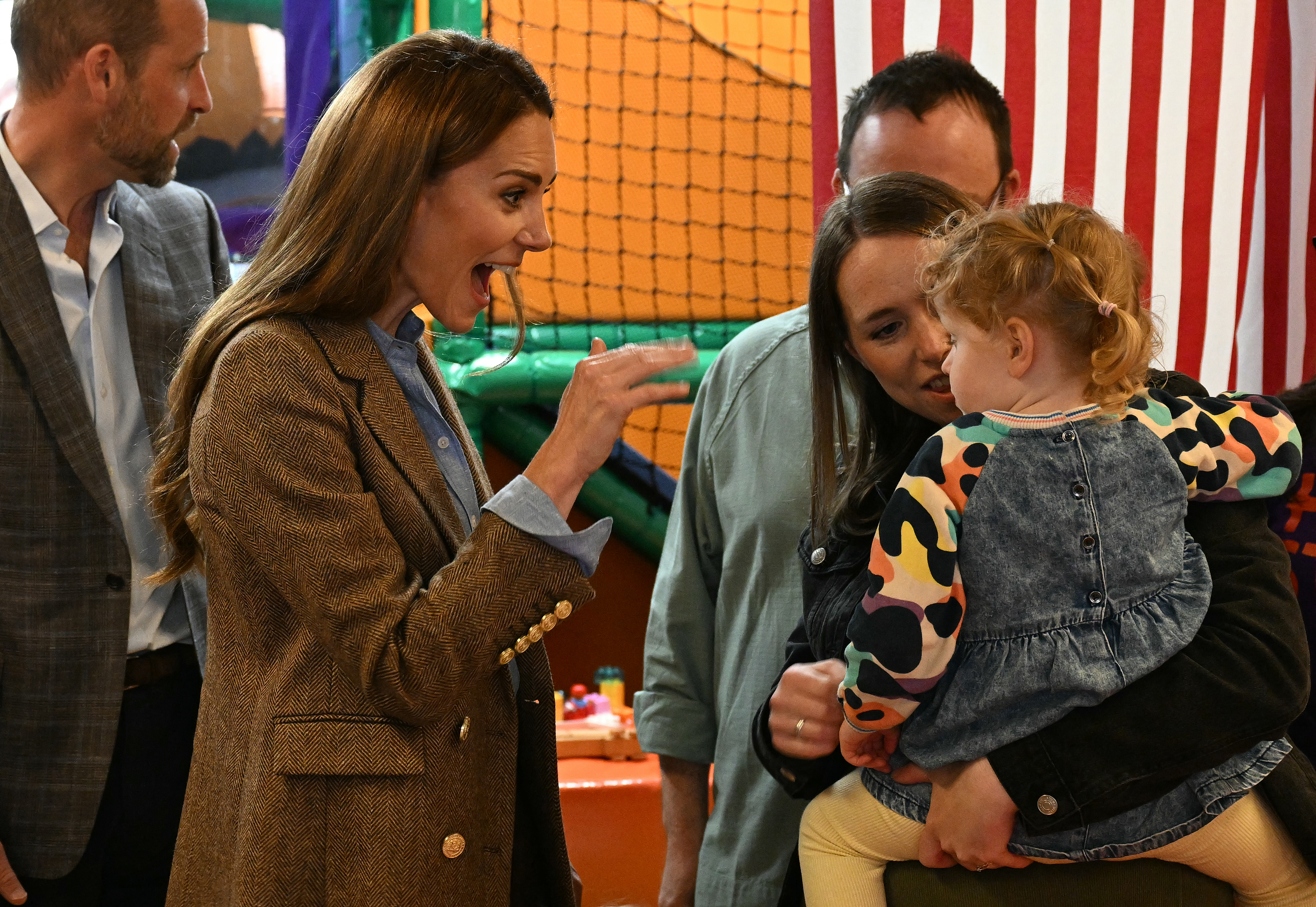 Kate Middleton smiling and waving at a little girl