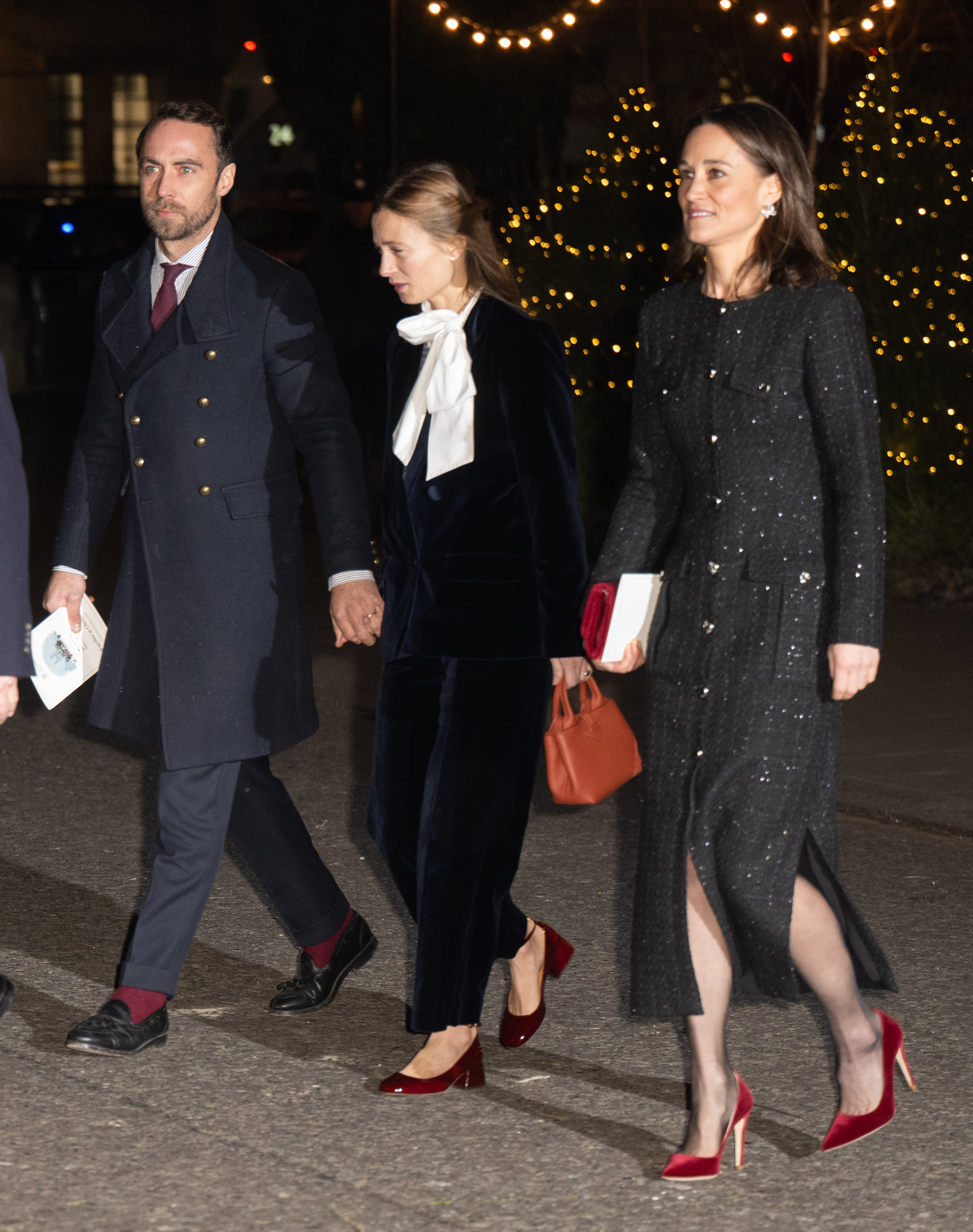 James and Pippa Middleton with Alizee Thevenet walking in front of a lit Christmas tree in December 2024