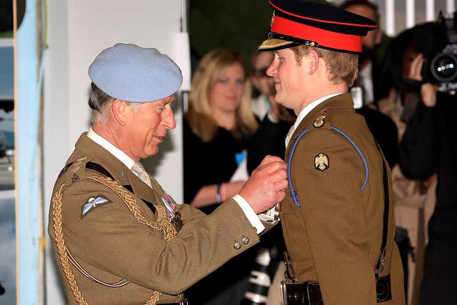 Chris Jackson/Getty Images Prince Charles pins on Prince Harry's flying wings on May 7, 2010